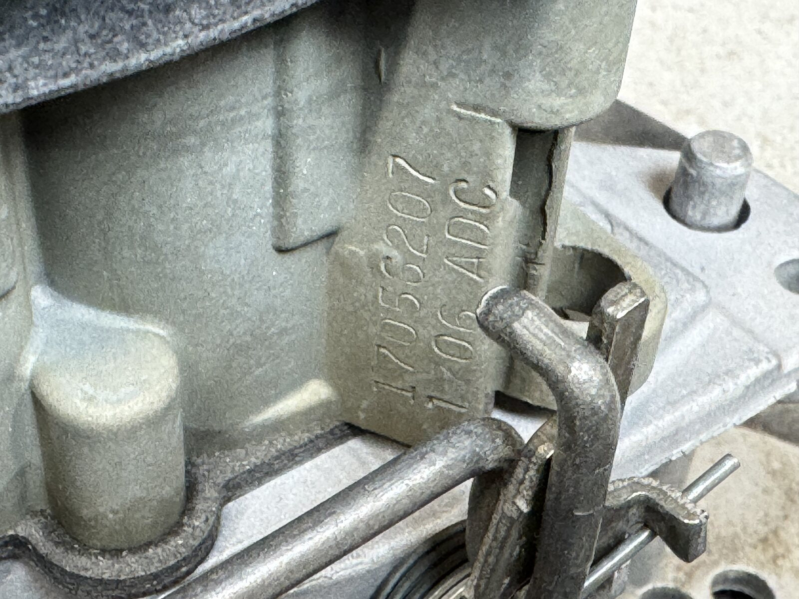 Quadrajet code stamped on the main body, driver side